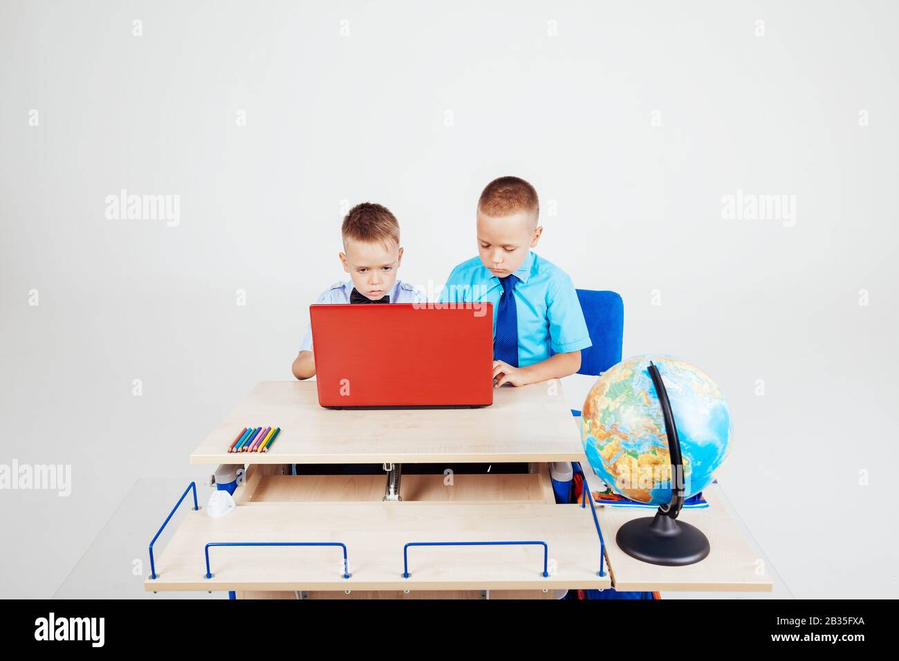 two boys sitting at the computer school Stock Photo - Alamy