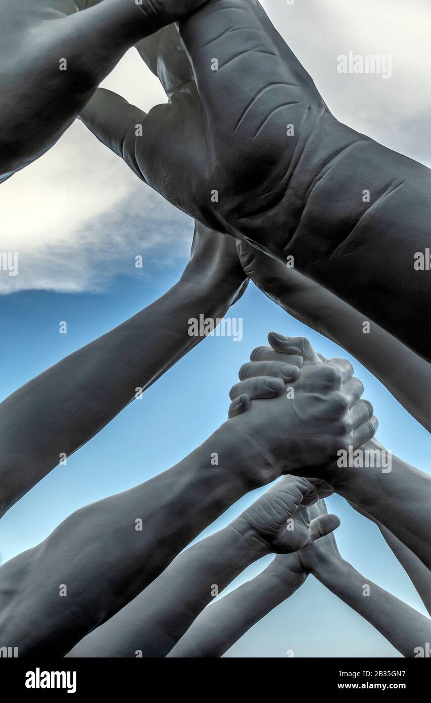 Italian artist Lorenzo Quinn builds bridges over Venice Arsenale, Italy. Six pairs of arching hands creating a bridge over a Venetian waterway, symbolic of the need to build bridges and overcome divisions. Stock Photo