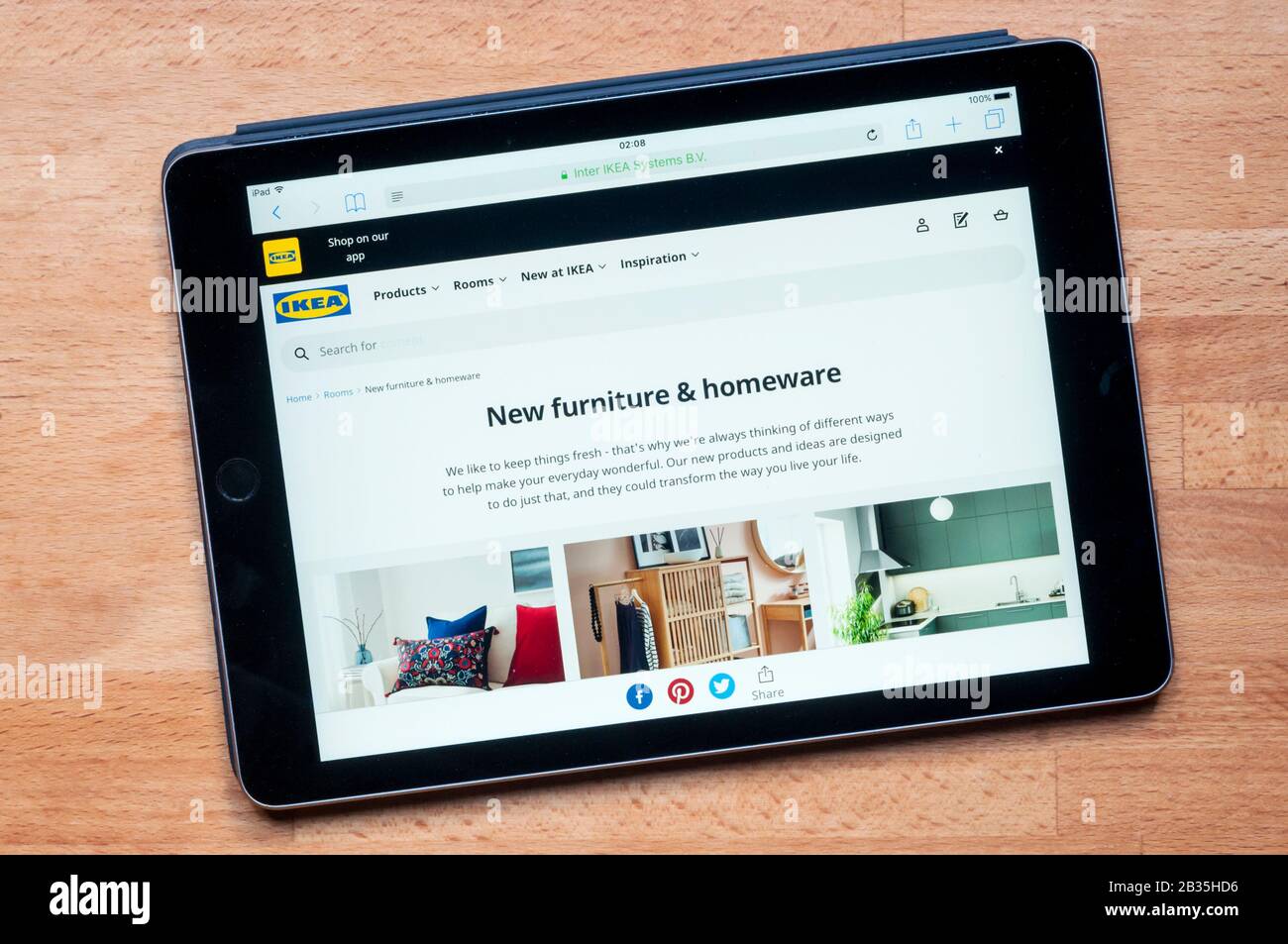 The website of Homebase furniture sellers & DIY store displayed on an iPad tablet computer against a pine worktop background. Stock Photo