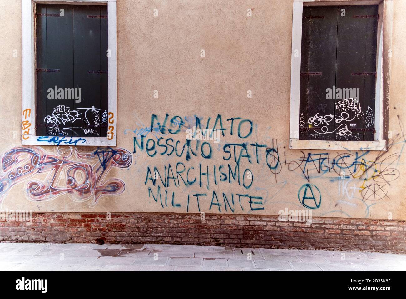 'militant anarchism' graffiti on a wall in Venice, Italy Stock Photo