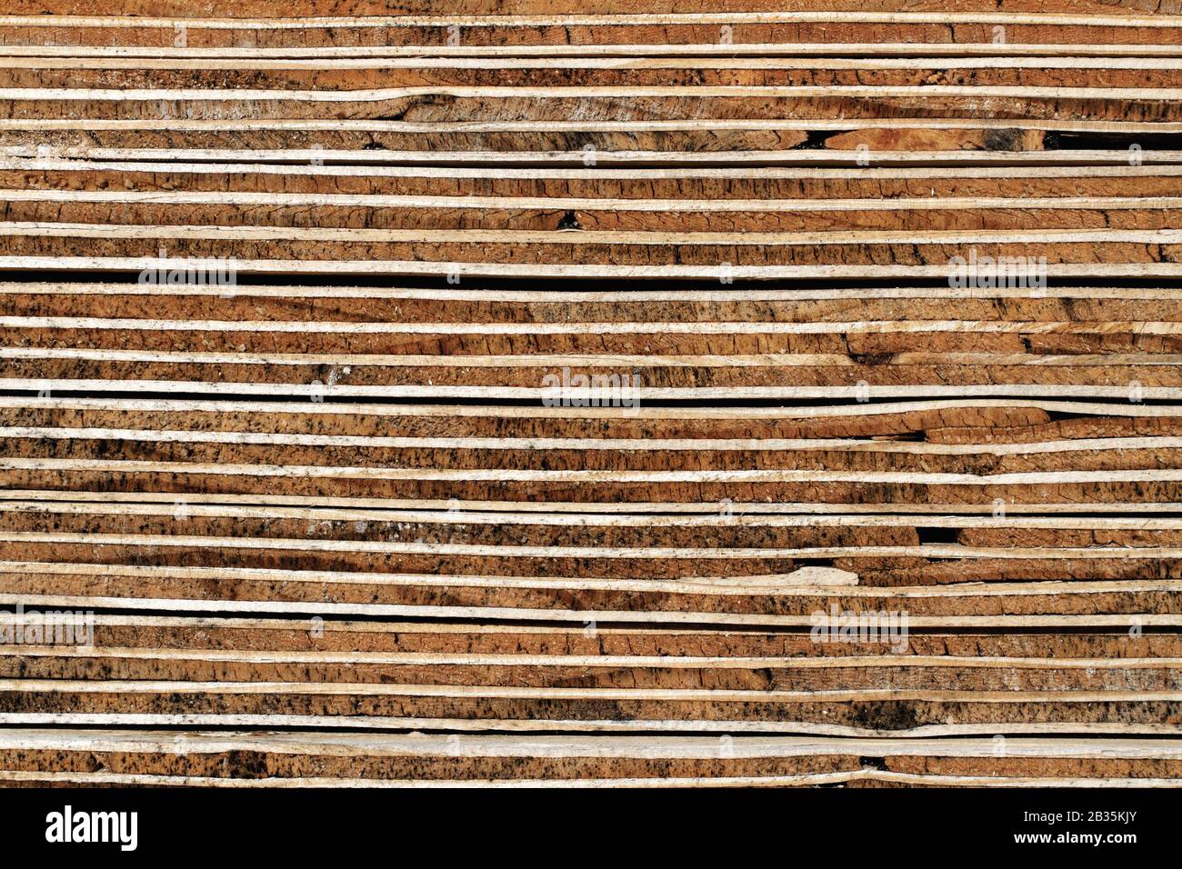 Plywood Background: Weathered Cross Section of Piled Plywood Panels - Detail:timber background showing the detailed view of piled plywood boards Stock Photo