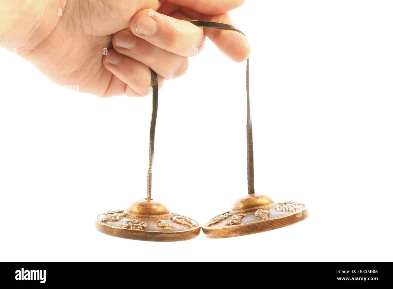 Playing Cymbal male hand holding and playing a bronze cymbal Stock