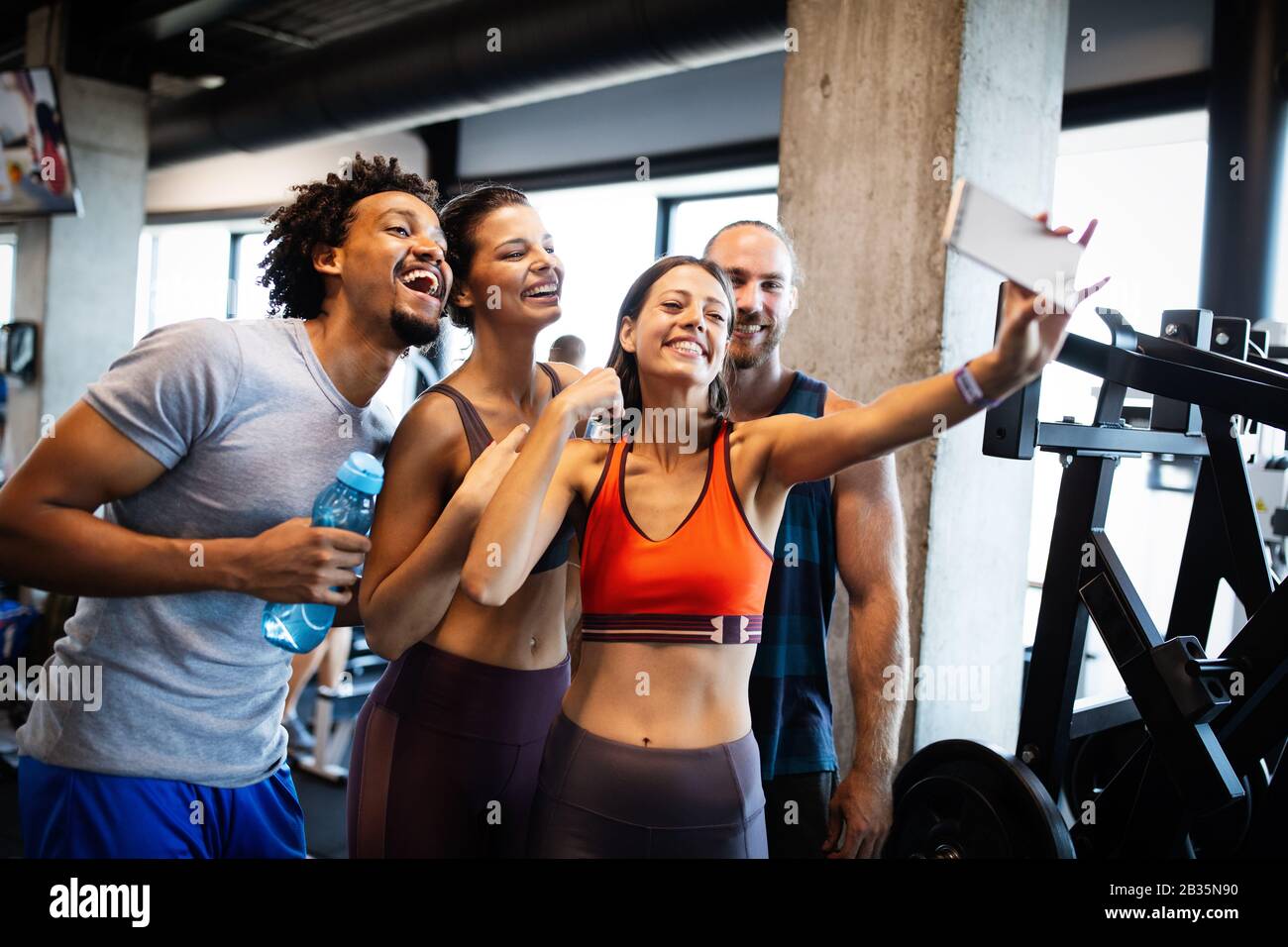 https://c8.alamy.com/comp/2B35N90/group-of-sportive-people-in-a-gym-taking-selfie-concepts-about-lifestyle-and-sport-in-fitness-club-2B35N90.jpg