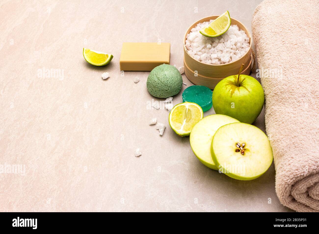 Spa concept, natural ingredients. Bath towel, sea salt with lime, apple