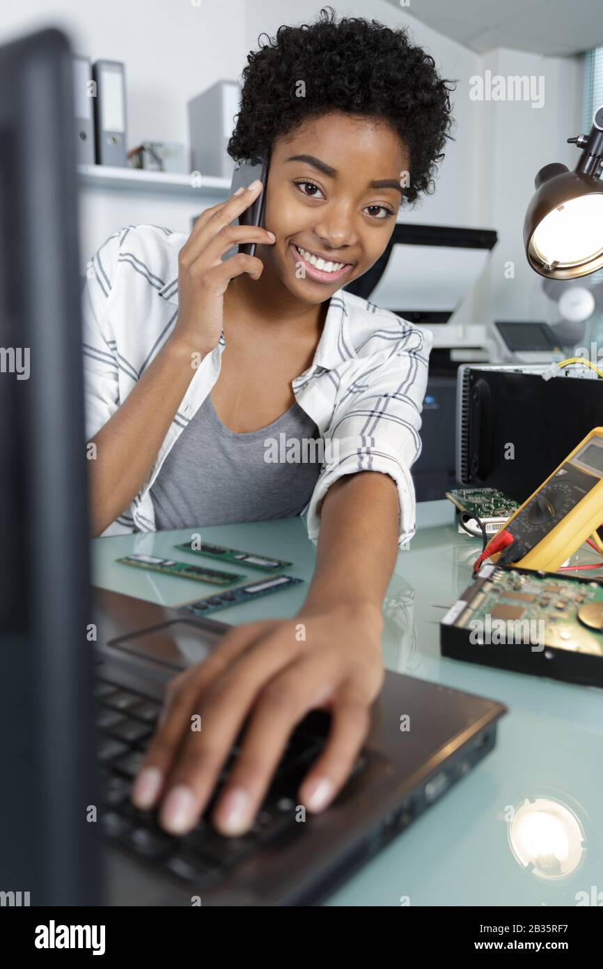 happy female technician using multimeter Stock Photo