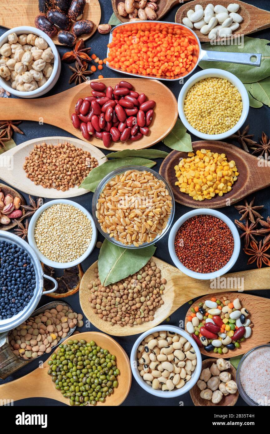 Legumes pulses background. Legumes variety flat lay. Pulses and herbs