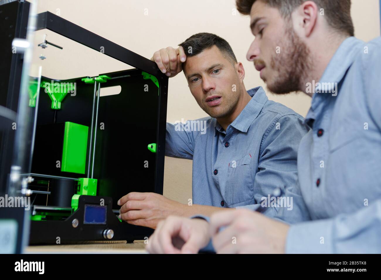 two male technicians using 3d printer Stock Photo