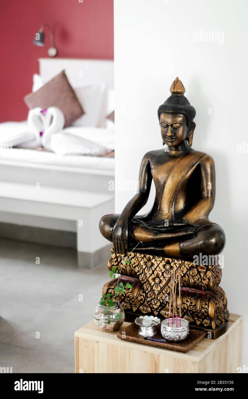 bronze buddha statue interior design detail in modern asian home living room  Stock Photo - Alamy