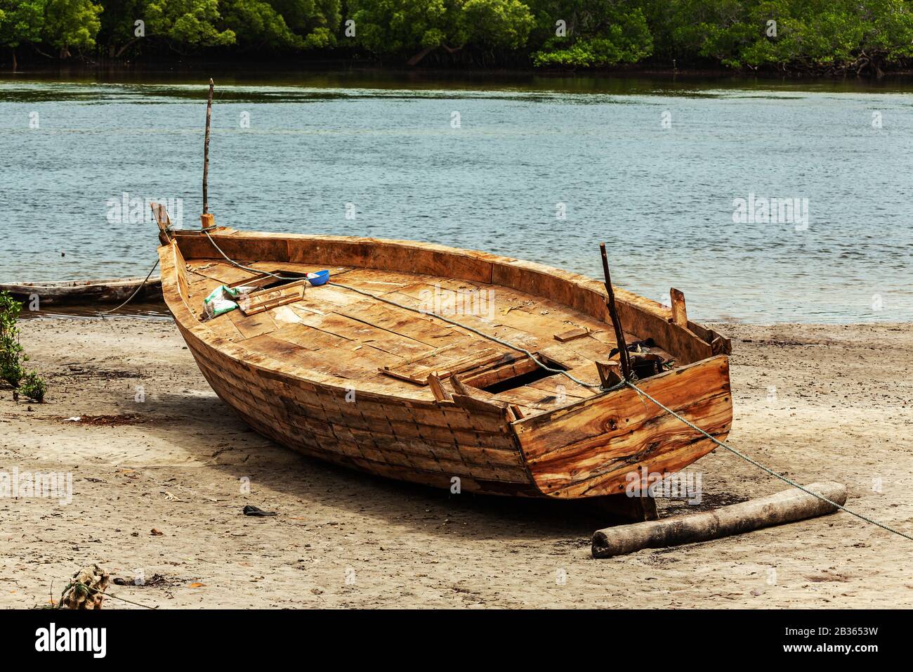 Fishing wooden boat on a beach near mangroves in Kenya Stock Photo