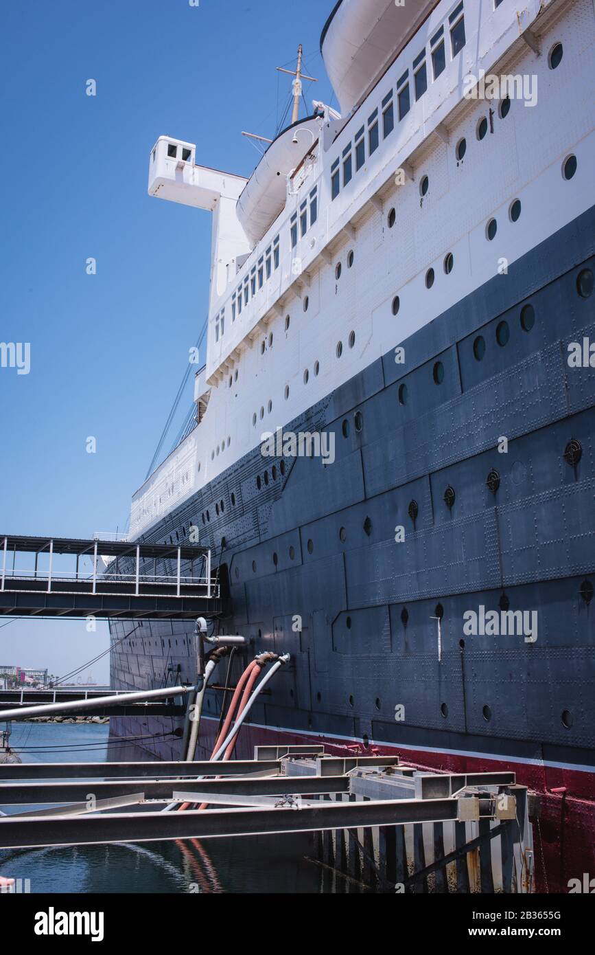 The Queen Mary, now retired, serves as a museum, restaurant, hotel, and lounge as it docks at Long Beach, California. Stock Photo