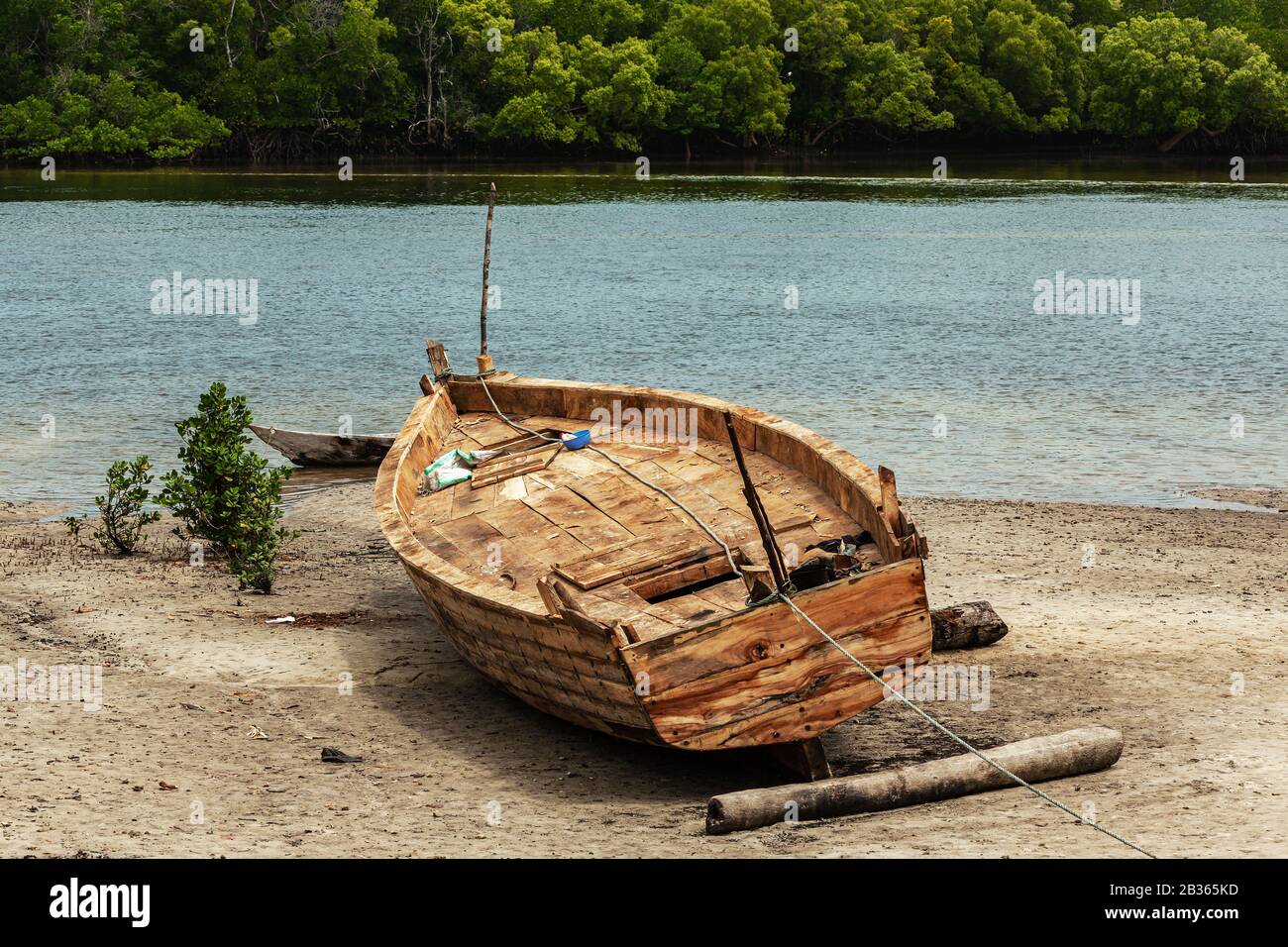 Fishing wooden boat on a beach near mangroves in Kenya Stock Photo