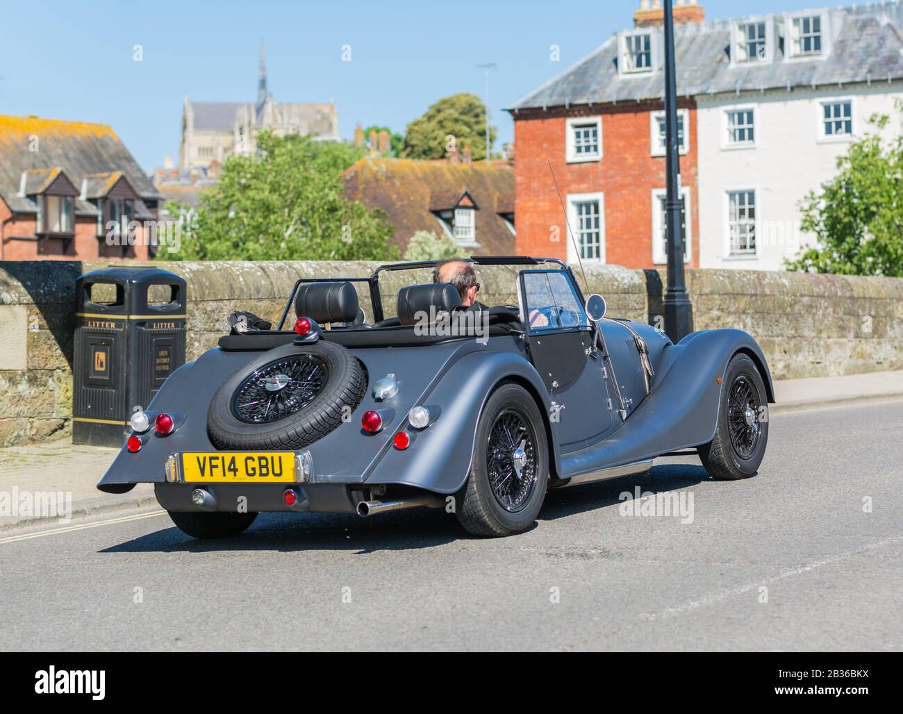 Man driving a 2014 Morgan 4/4 (Morgan Four Four) car, a small convertible sports car with the top down in Summer in England, UK. Stock Photo