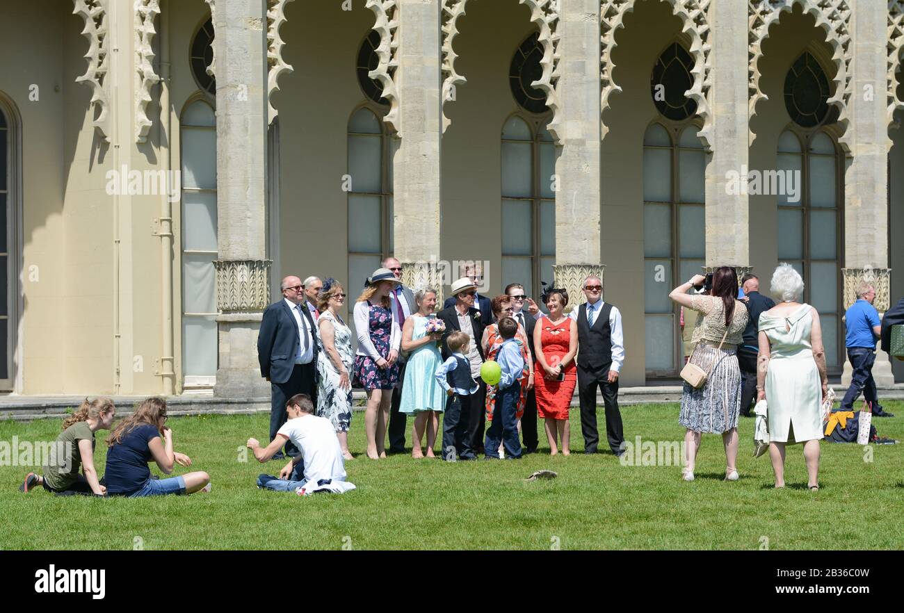 Group of guests and wedding party posing for photos for a wedding photographer at a wedding in England, UK. Stock Photo