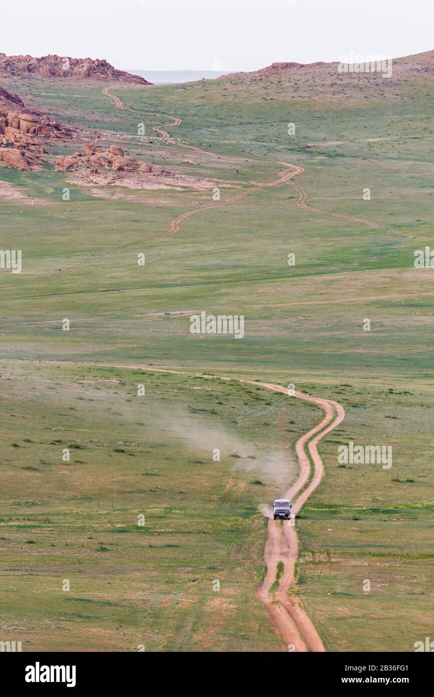 Mongolia, Dundgovi province, steppe landscape and Chuluu Mountains near Mandalgovi, Russian jeep UAZ 469 on a dusty road Stock Photo