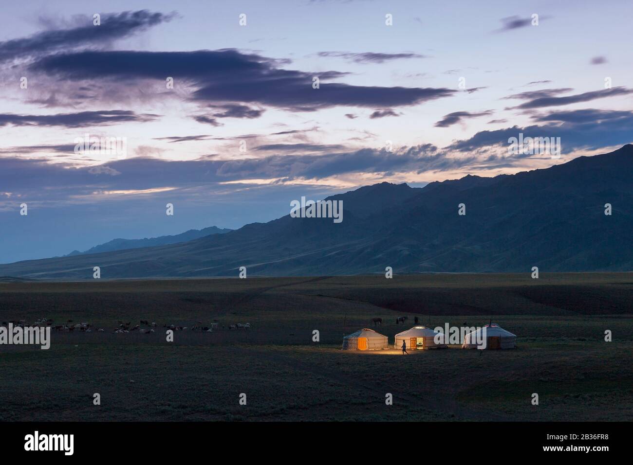 Mongolia, Omnogovi province, near Dalanzadgad, elevated view of a steppe landscape and yurts lit by a tourist's torch Stock Photo