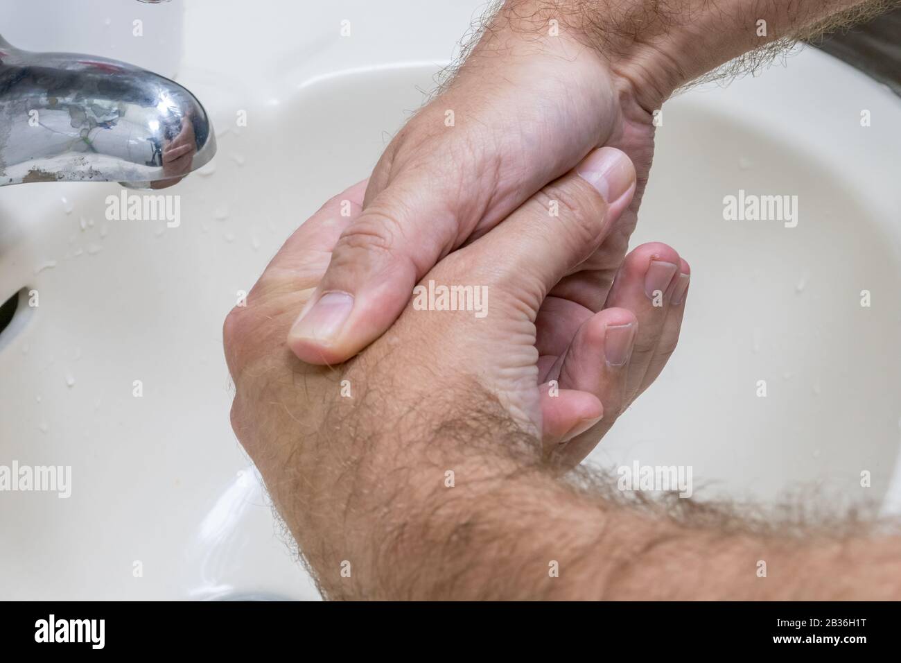 Man washing hands in basin close-up, one of several in handwashing steps series Stock Photo