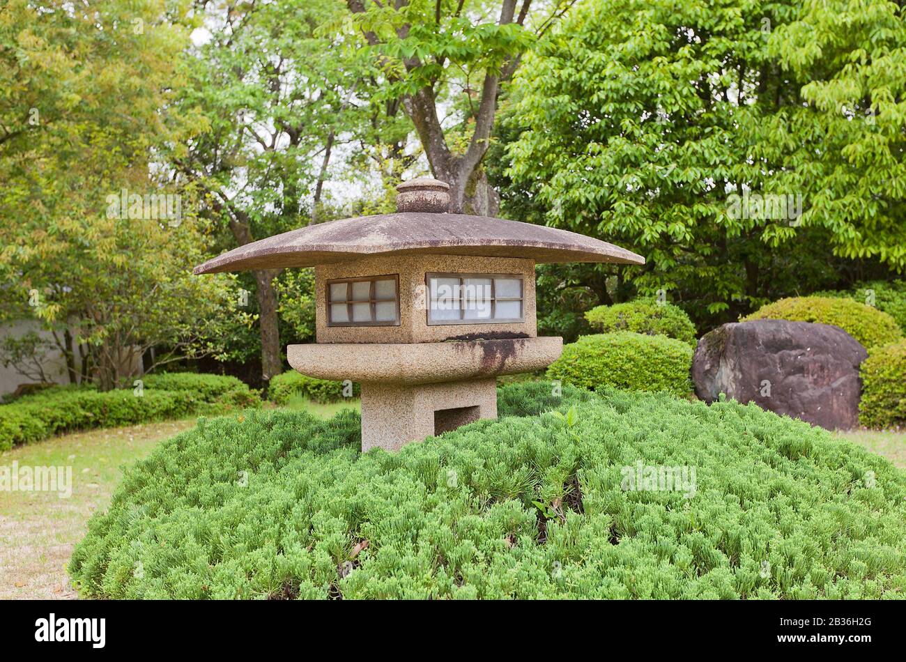 Traditional stone lantern (toro) in Kokoen Garden near Himeji castle, Japan. Garden was laid out in 1992 to commemorate 100 anniversary of Himeji city Stock Photo
