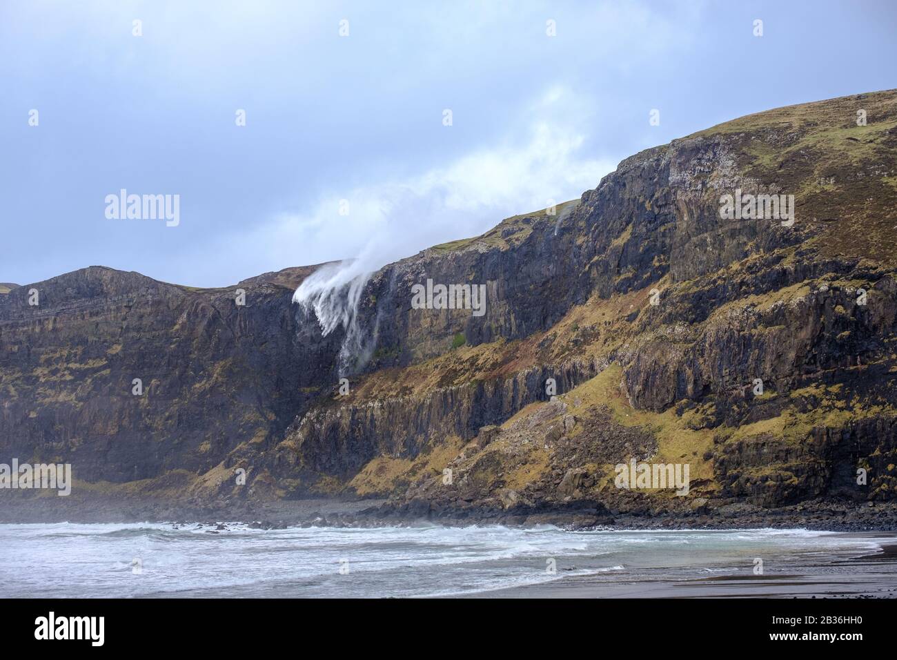 Waterfall at Talisker Bay, Skye, Inner Hebrides, appearing to flow upwards due to strong storm winds Stock Photo