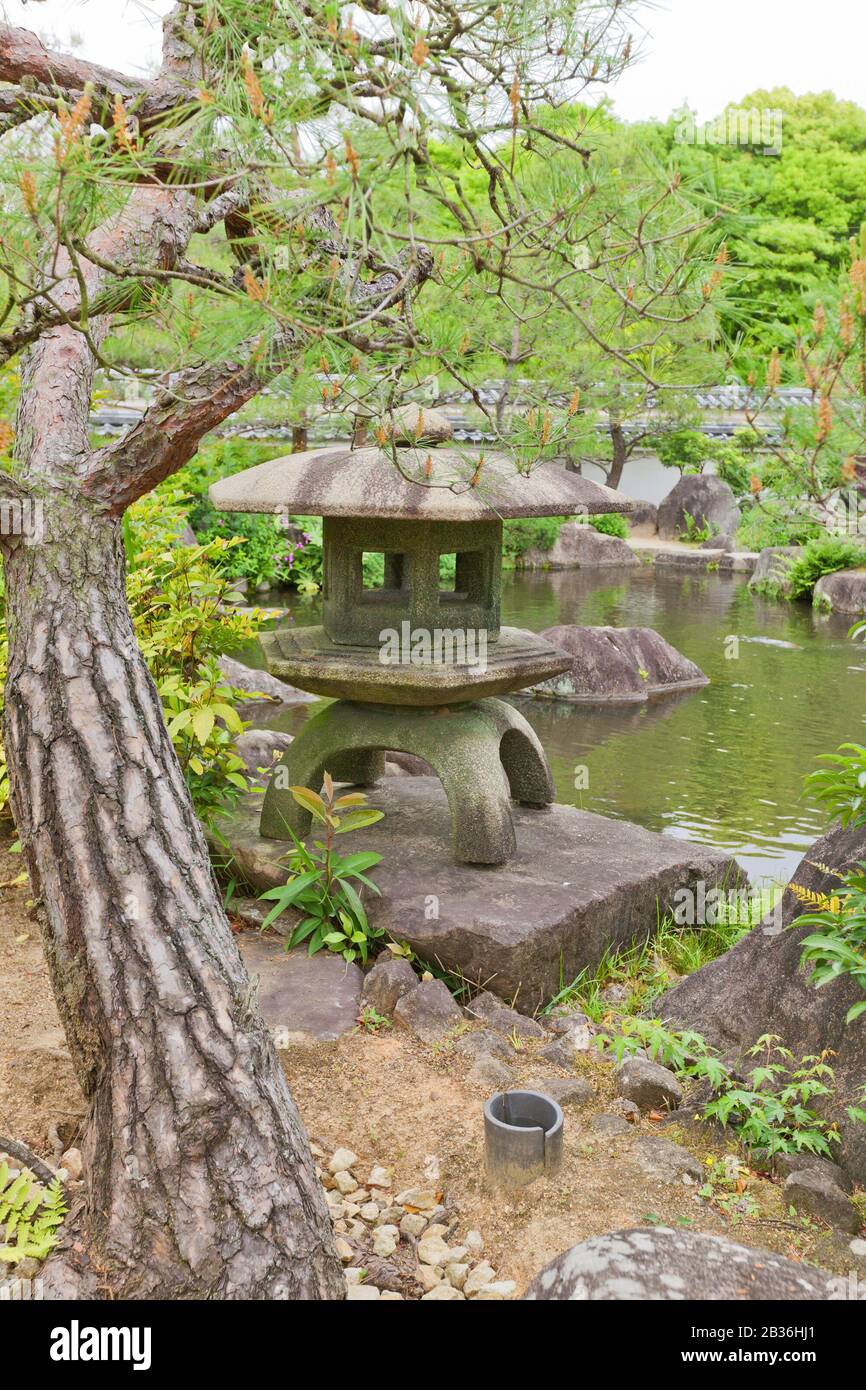 Traditional stone lantern (toro) on the pond of Kokoen Garden near Himeji castle, Japan. Garden was laid out in 1992 Stock Photo