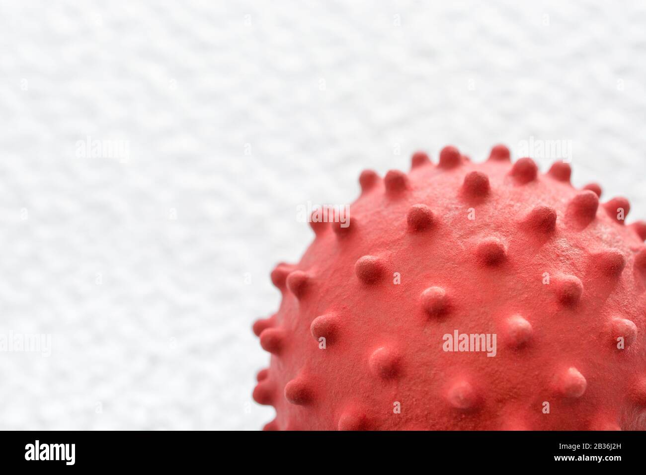 Isolated coronavirus model on textured white b/g. For Covid-19, flu virus, SARS, MERS. Medical abstract, infectious disease, virology, virus research. Stock Photo