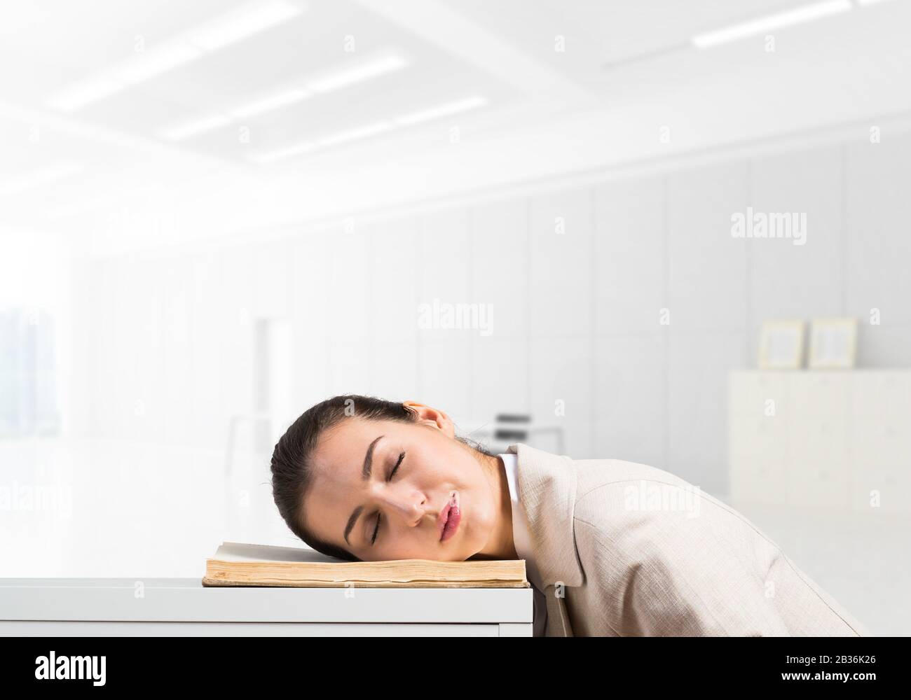 Exhausted business woman sleeping on desk Stock Photo - Alamy