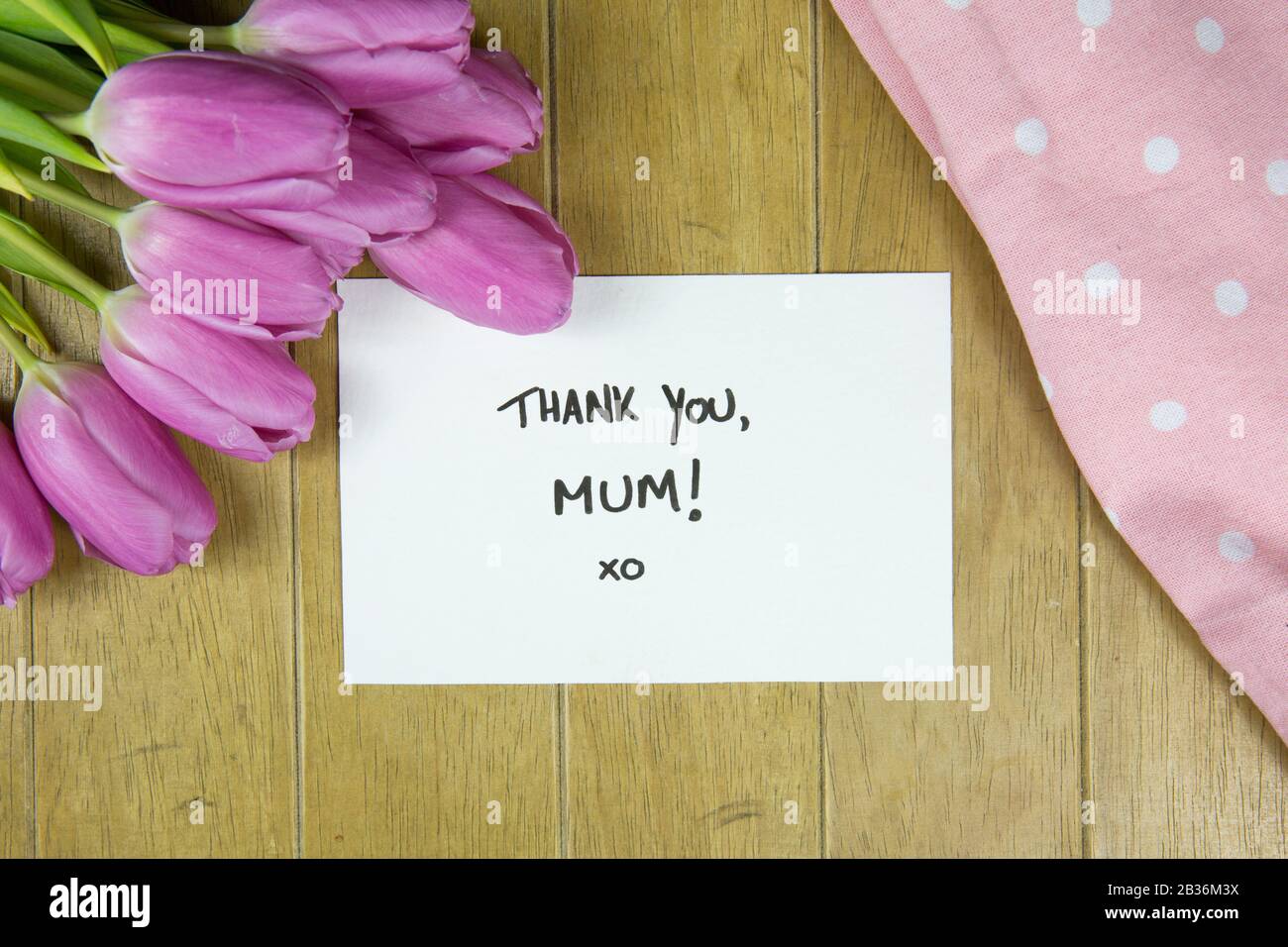 Mothering Sunday Mother's Day UK England breakfast tray with thank you note to Mum and pink tulips Stock Photo