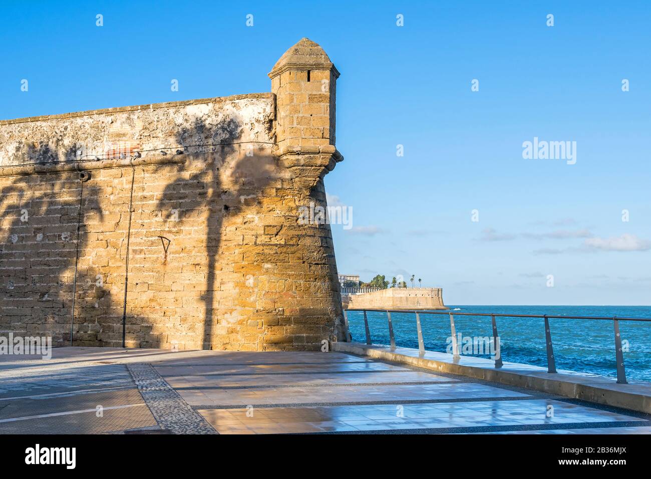 One of the bastions of the San Carlos Wall (Murallas De San Carlos) with the shadow of palm trees and the bastion Baluarte de la Candelaria in the bac Stock Photo