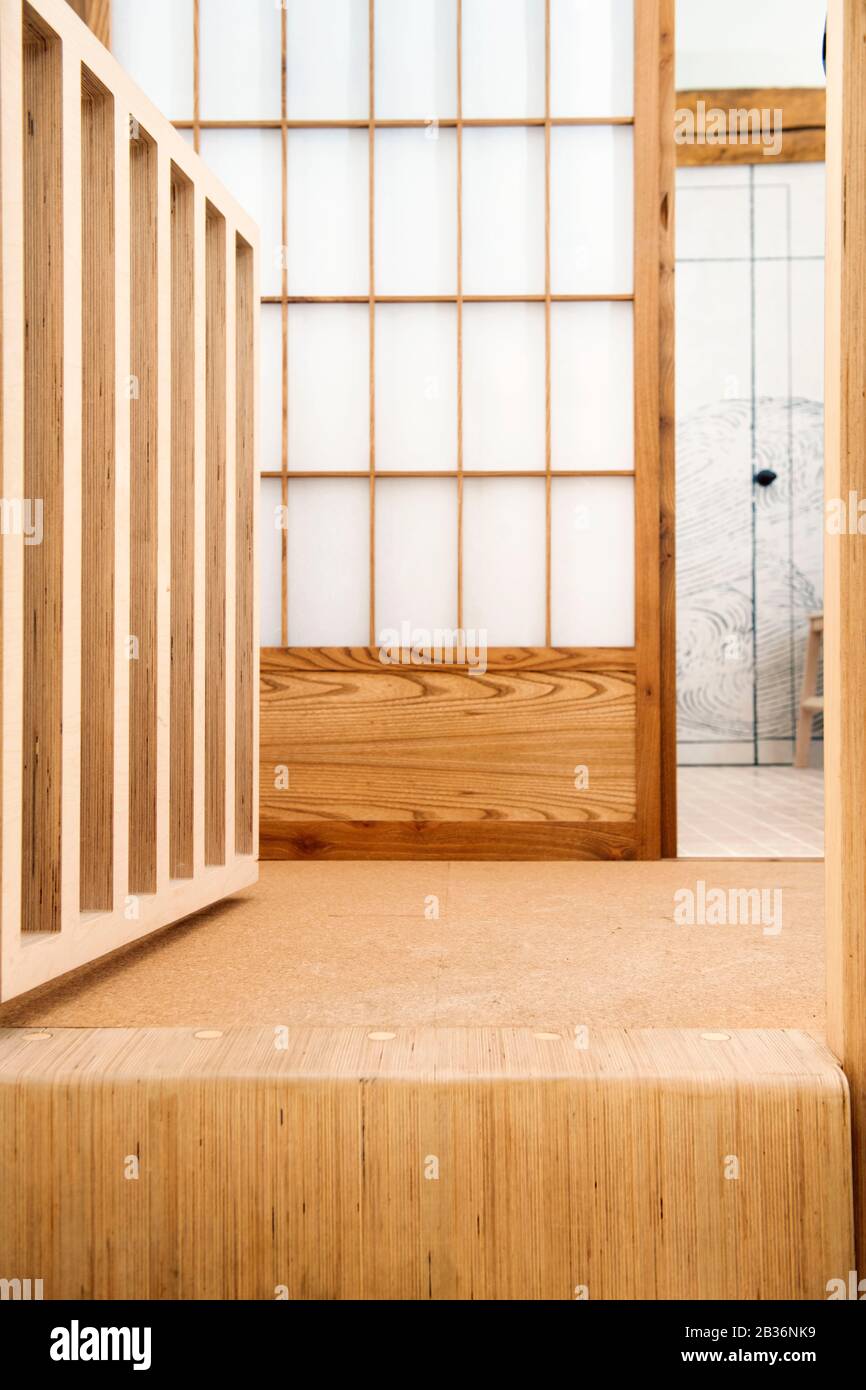 Detail of a bespoke plywood staircase and Japanese Shoji screen in a barn conversion near Stroud, Gloucestershire UK Stock Photo