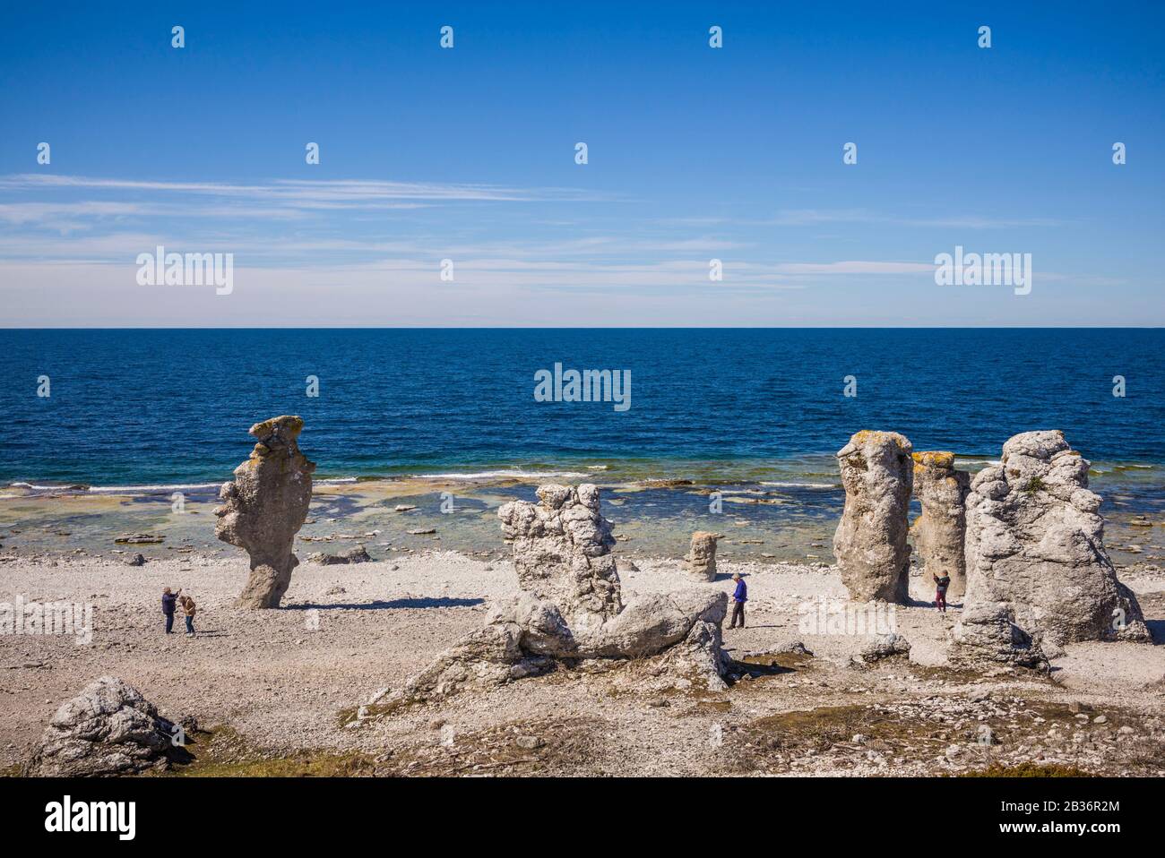 Sweden, Faro Island, Langhammars Area, Langhammar coastal limestone raukar rocks with visitors Stock Photo