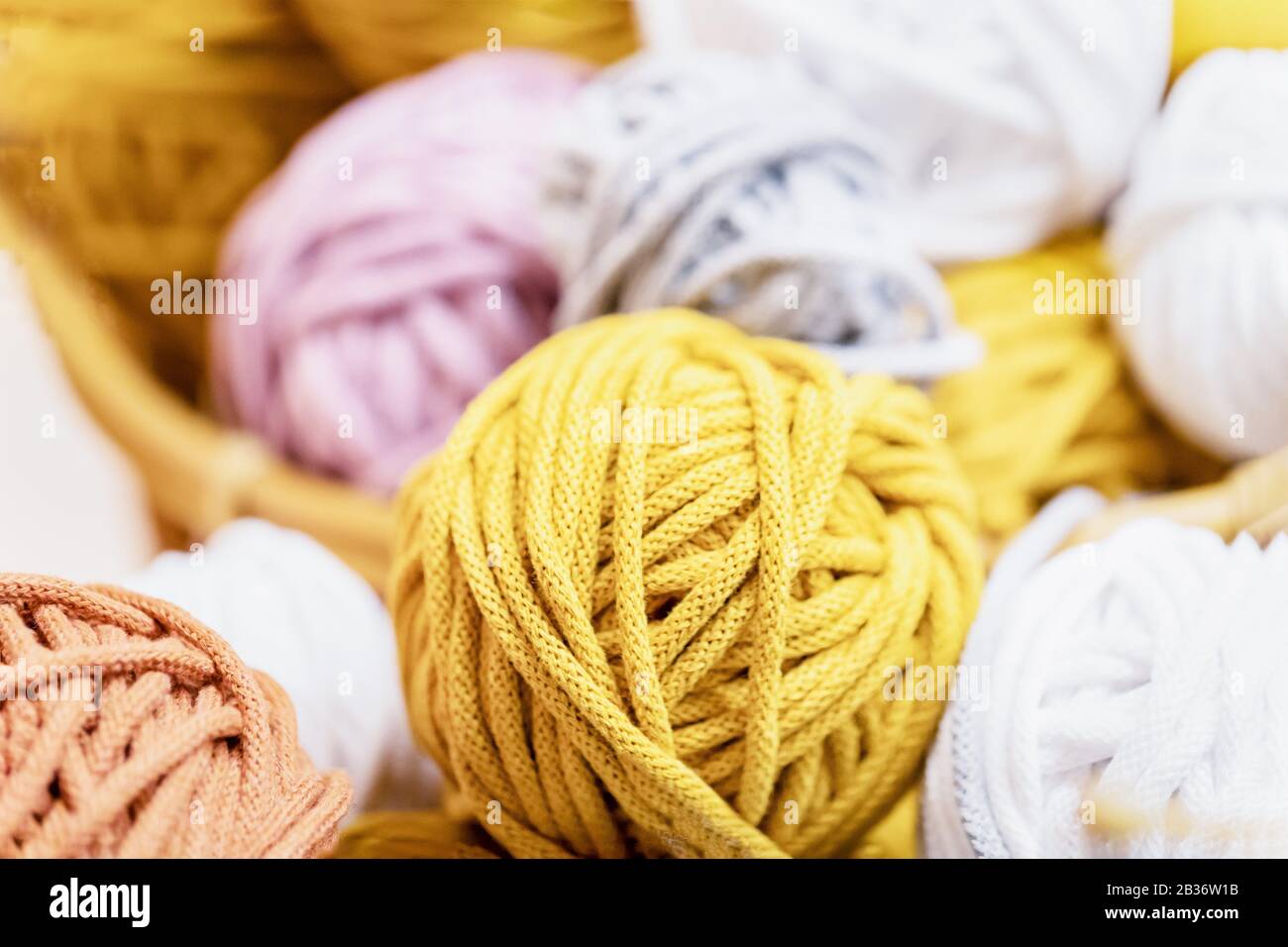 White, yellow, mustard, gray cotton thread balls background Stock Photo