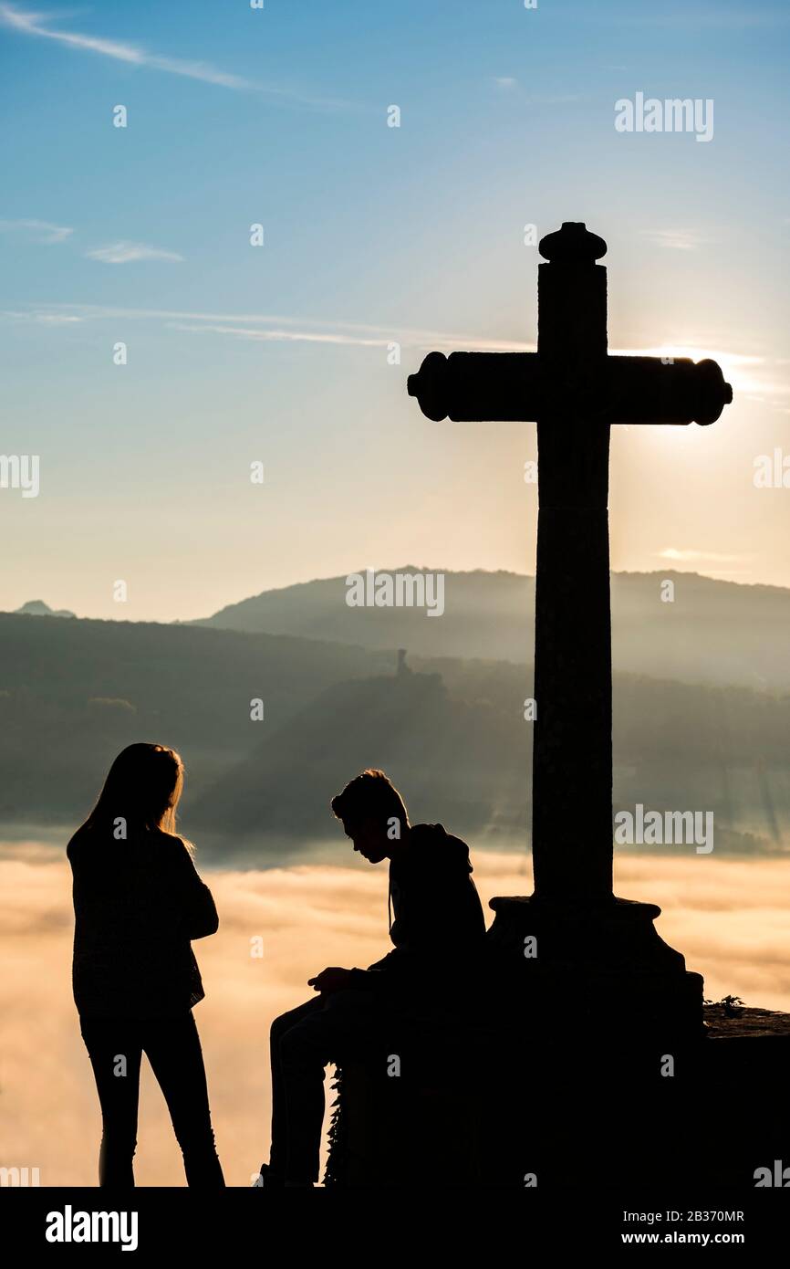 France, Puy de Dome, couple at the foot of a cross, Natural Regional Park of  Livradois Forez and in the background the Auvergne Volcanoes natural park  Stock Photo - Alamy