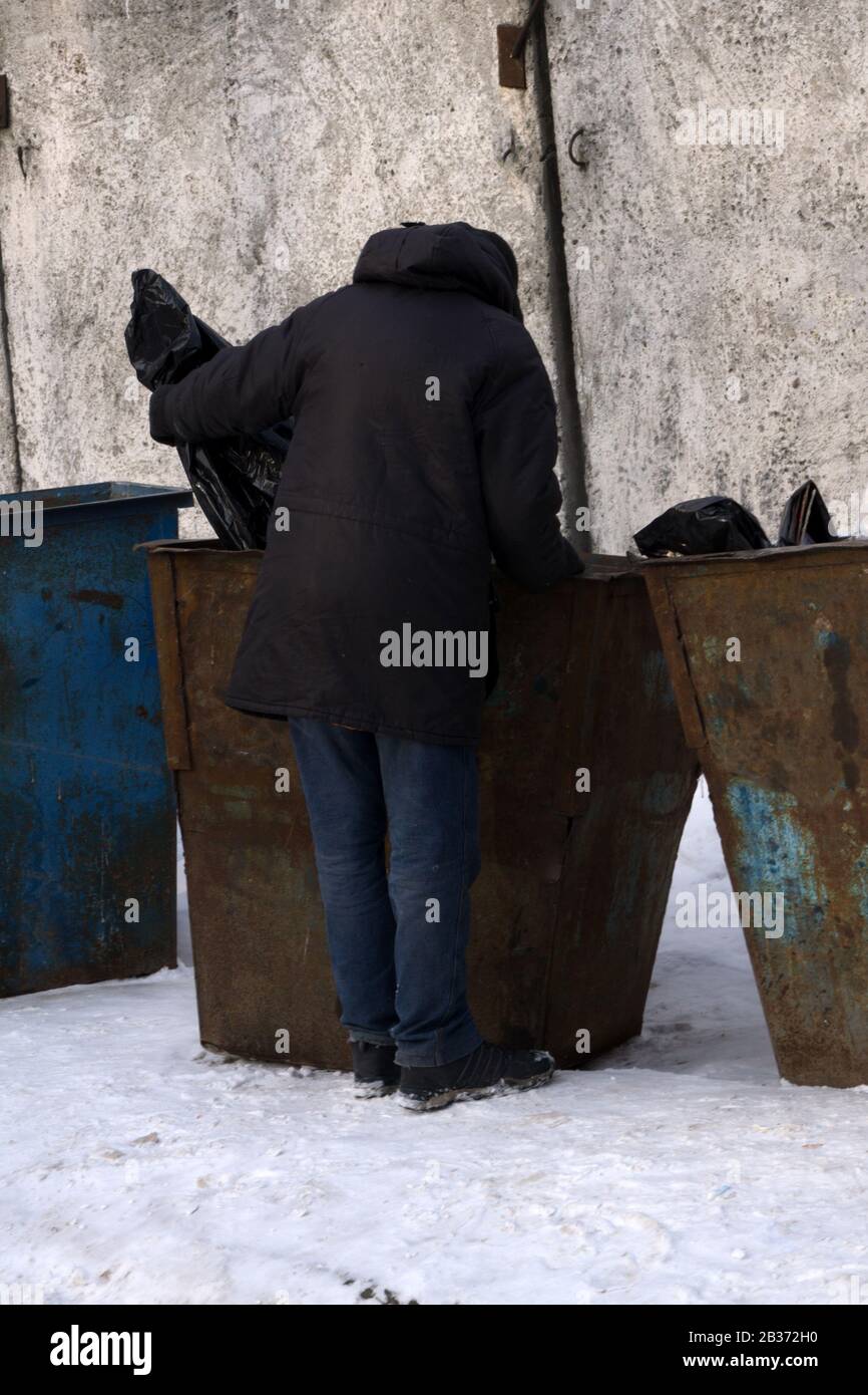 Garbage removal men working for a public utility emptying trash
