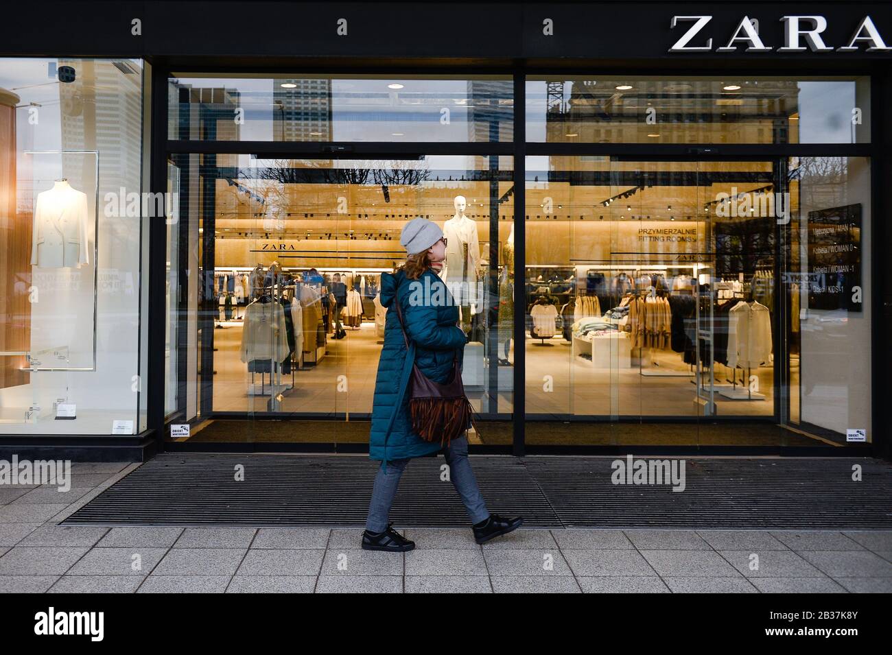 A woman walks past a Spanish clothing store chain Zara Stock Photo - Alamy