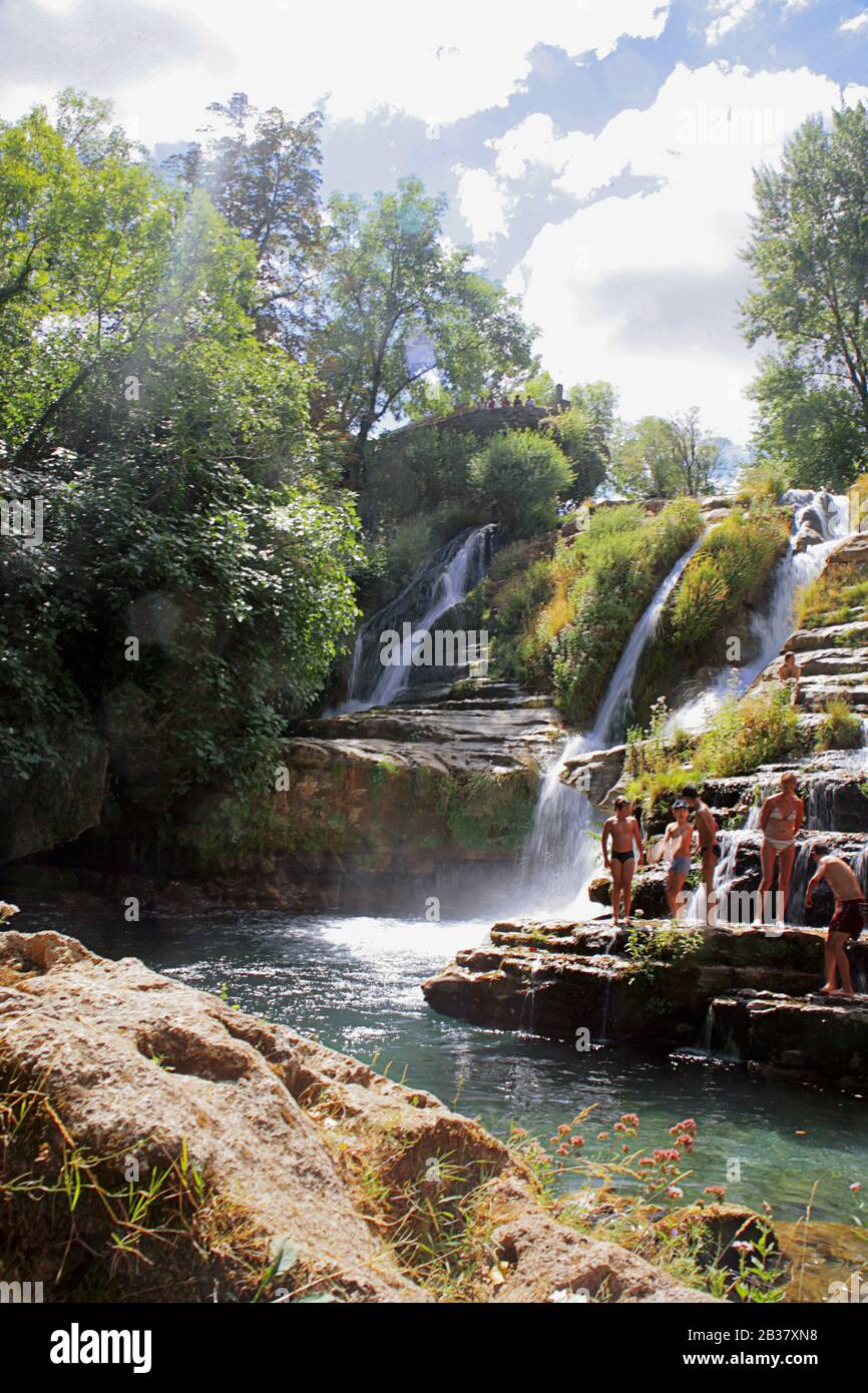 Swimmers at the waterfall by the ancient hamlet of  Saint-Maurice-Navacelles, Cirque de Navacelles, Gorges de la Vis, Hérault,  Occitanie, France Stock Photo - Alamy