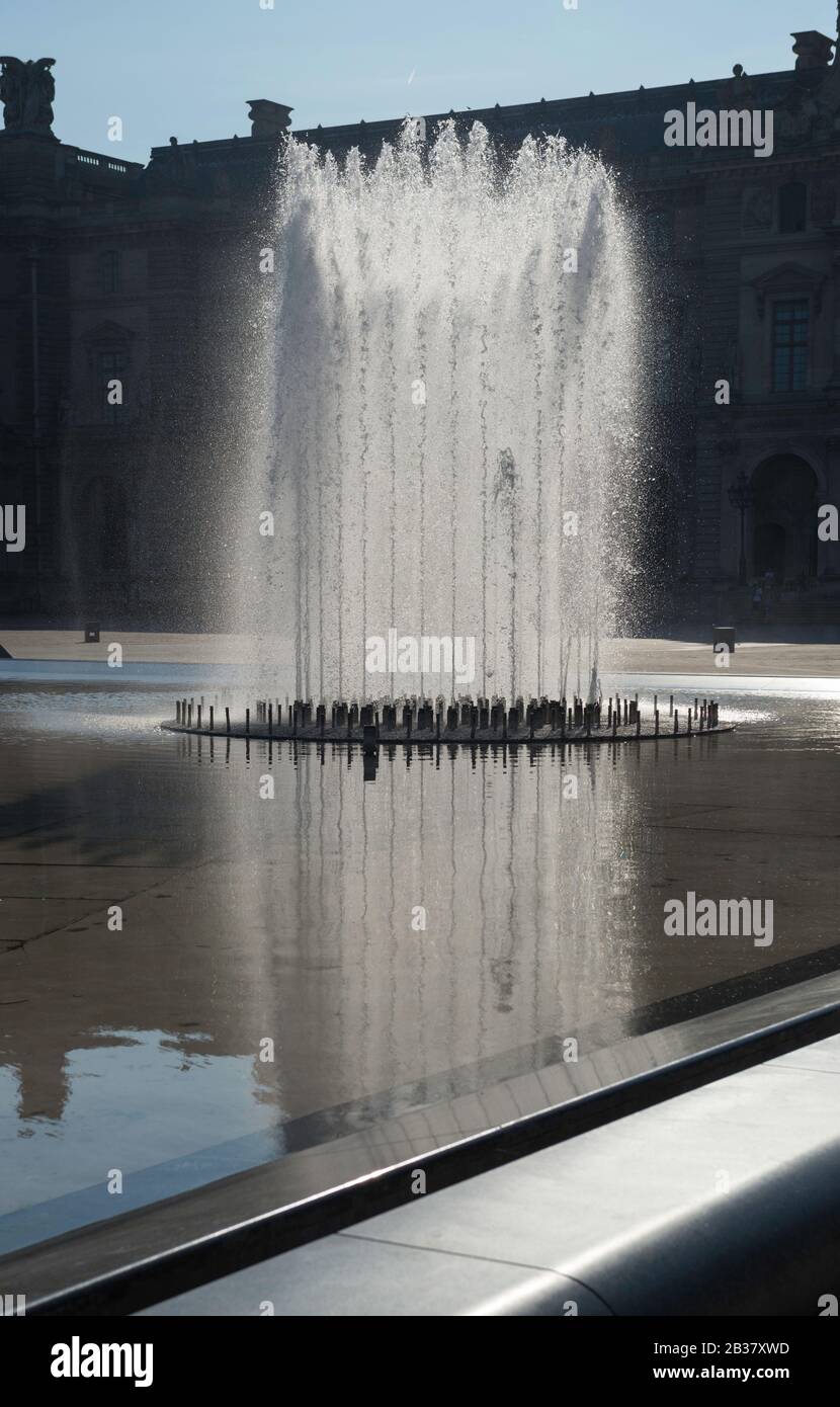 Backlit fountains in the courtyard of the Louvre museum in Paris
