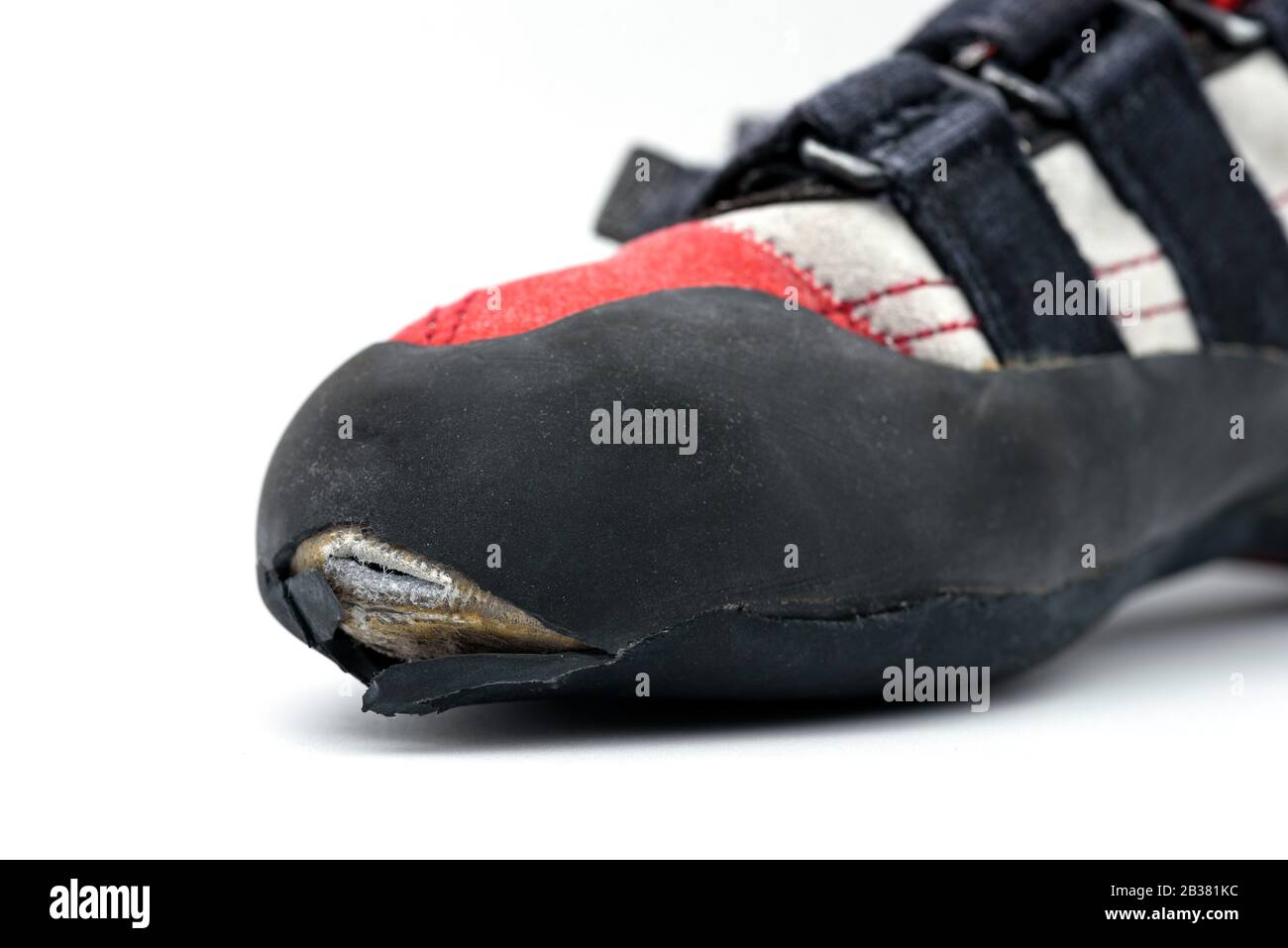 Worn climbing shoe requiring a full upper rubber replacement, isolated on white background Stock