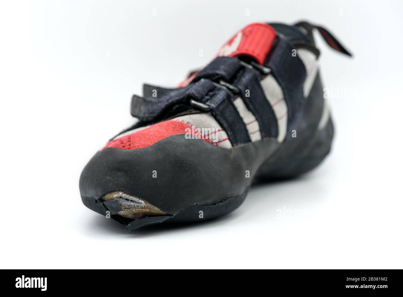 Worn climbing shoe requiring a full upper rubber replacement, isolated on white background Stock
