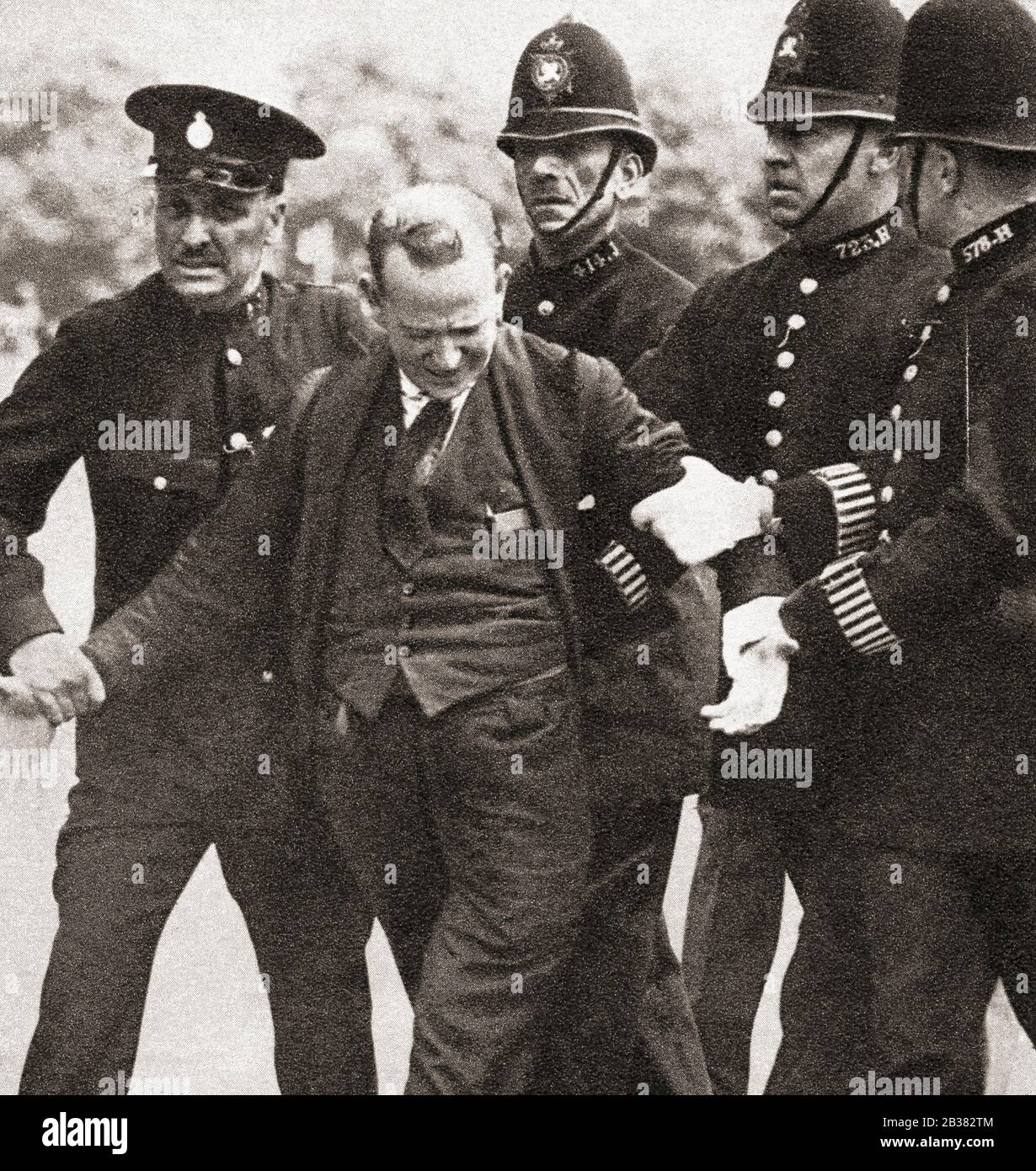 George McMahon under arrest for producing a revolver with intent to alarm king Edward VIII, 1936, he was sentenced to 12 months imprisonment and hard labor. George Andrew Campbell McMahon, d. 1970, aka Jerome Bannigan.  From The Coronation Souvenir Book, published 1937. Stock Photo