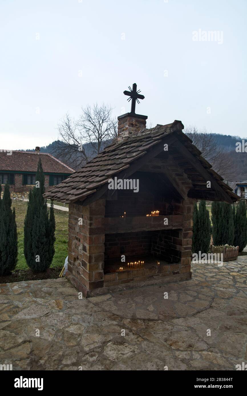 Koviljaca Spa, Sunny River, January 26, 2019. A religious building next to a small church where believers light candles for the living and the dead. Stock Photo