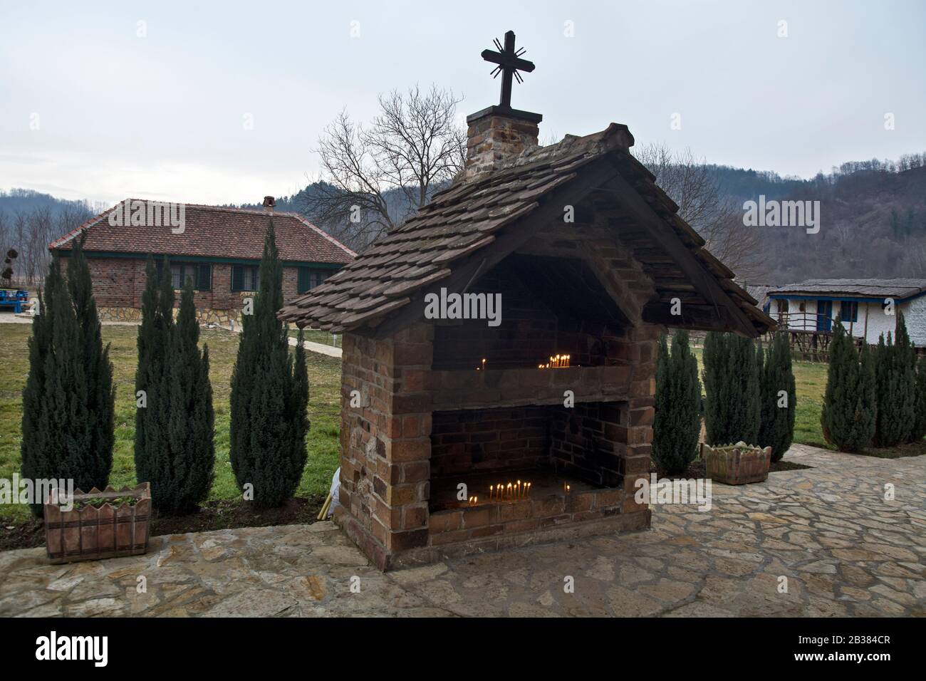 Koviljaca Spa, Sunny River, January 26, 2019. A religious building next to a small church where believers light candles for the living and the dead. Stock Photo