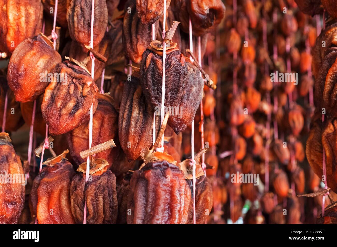Dried persimmon suspended on a rope, airdrying dried fruits. For
