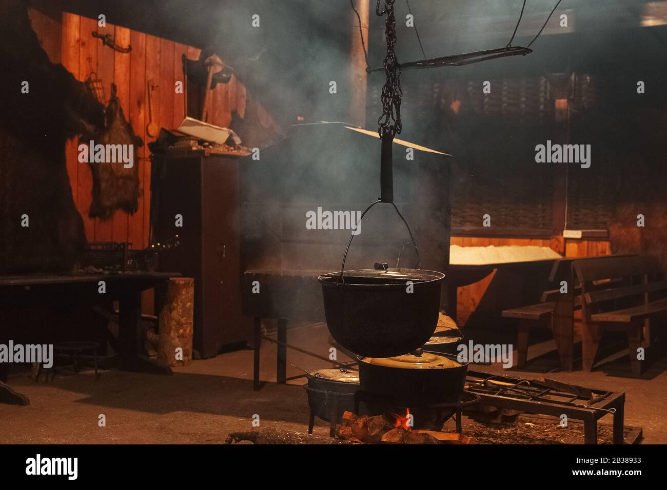 Large cooking pots are prepared using firewood.Metal boilers over a