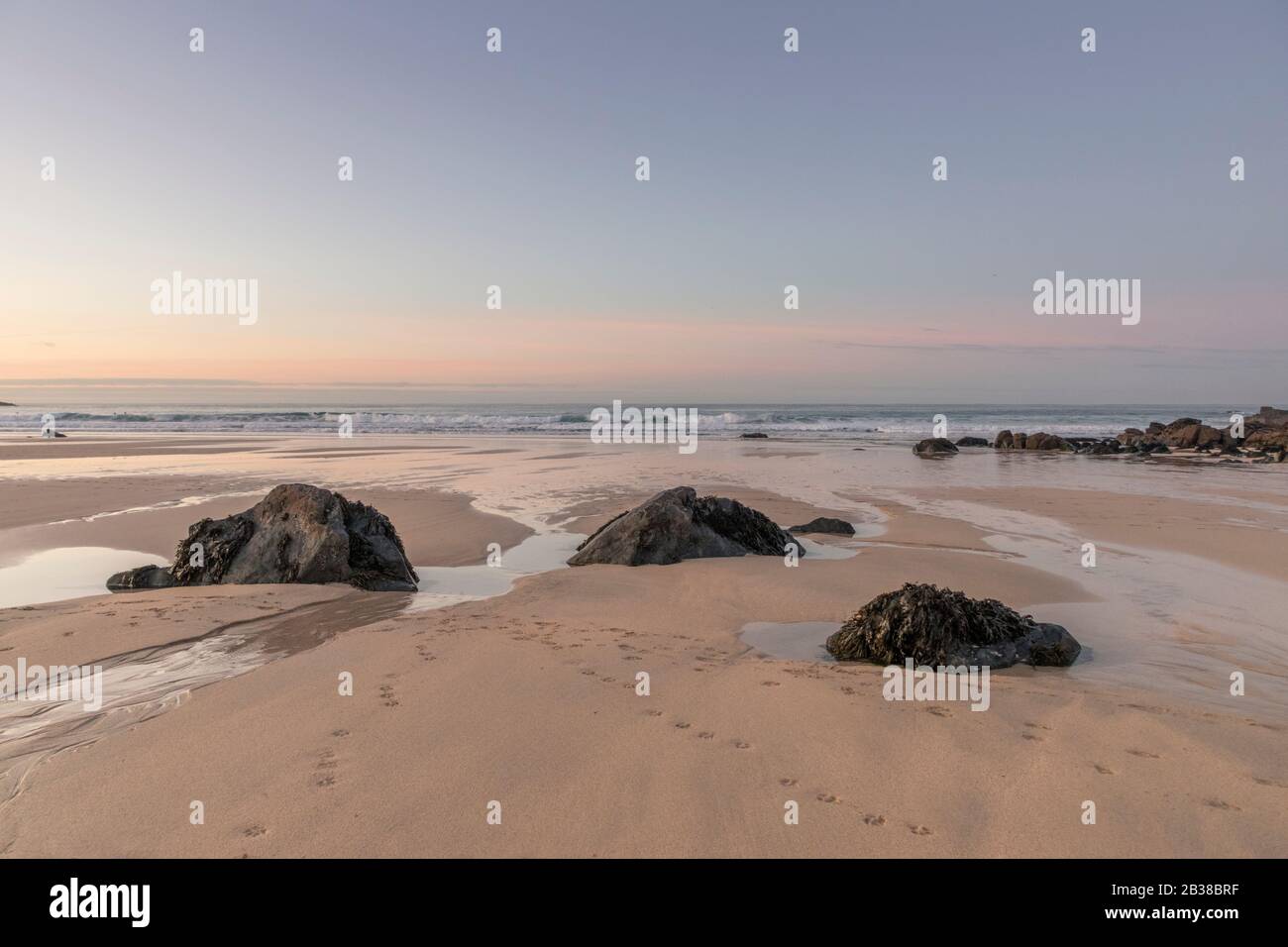 Sunset from Porthmeor Beach, St Ives, looking towards the Island Stock Photo