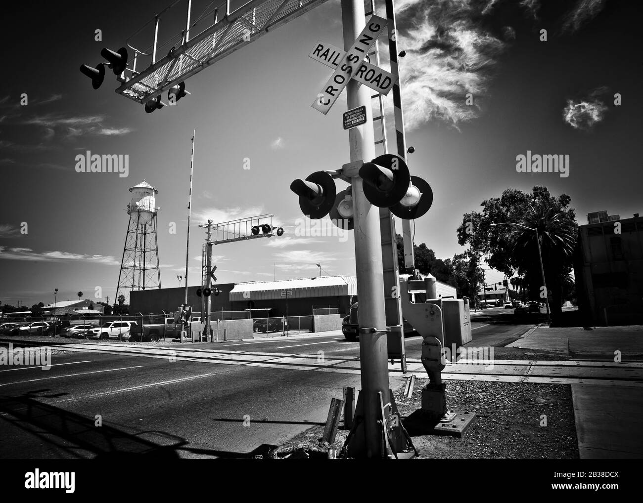 black and white view, classic image of road and railroad crossing point, small town of Patterson,California,USA Stock Photo