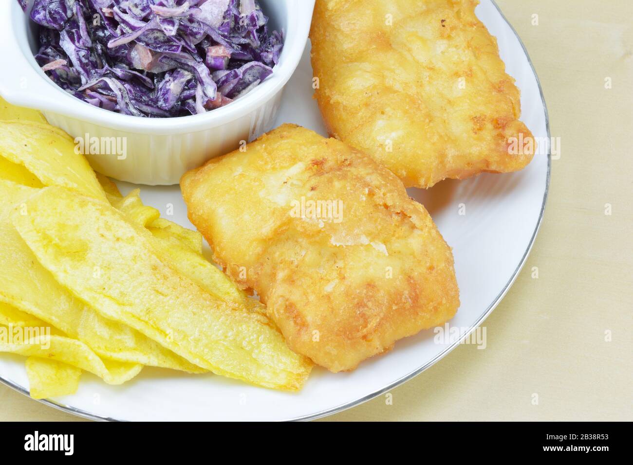 Cod fish , french fries and salad with red cabbage,carrot, onion and mayonnaise Stock Photo Alamy