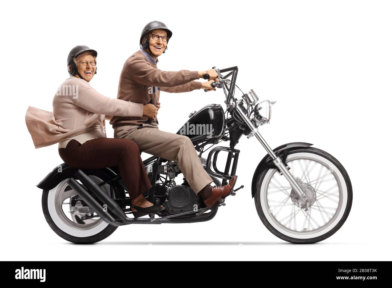 Cheerful senior man and woman riding a custom motorbike and smiling at the camera isolated on white background Stock Photo