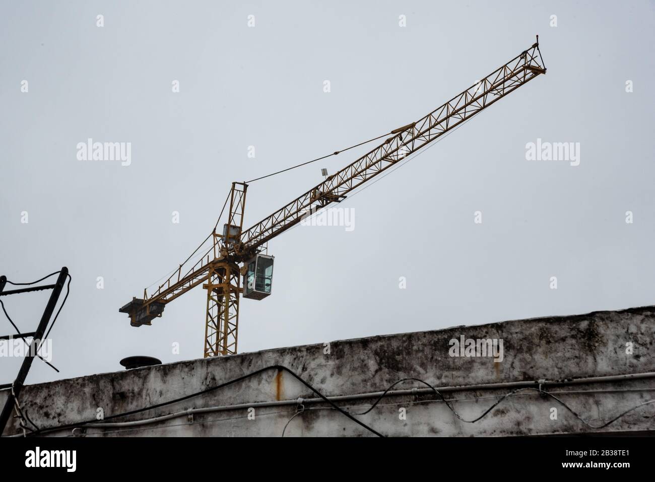 Isolated empty construction crane on a cloudy and rainy day Stock Photo