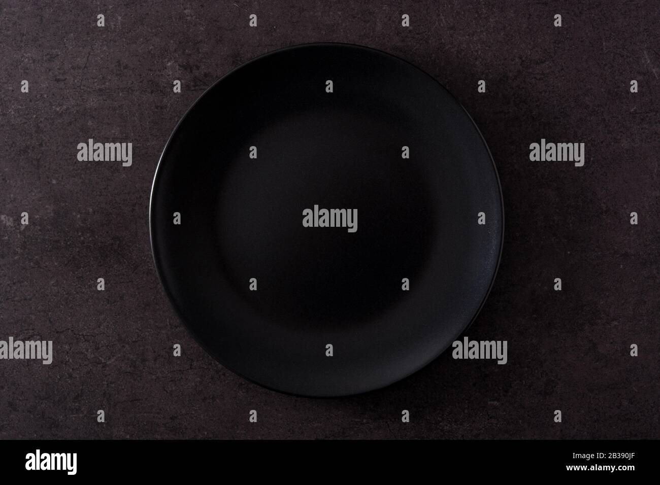 Black plate empty on slate background. Top view Stock Photo