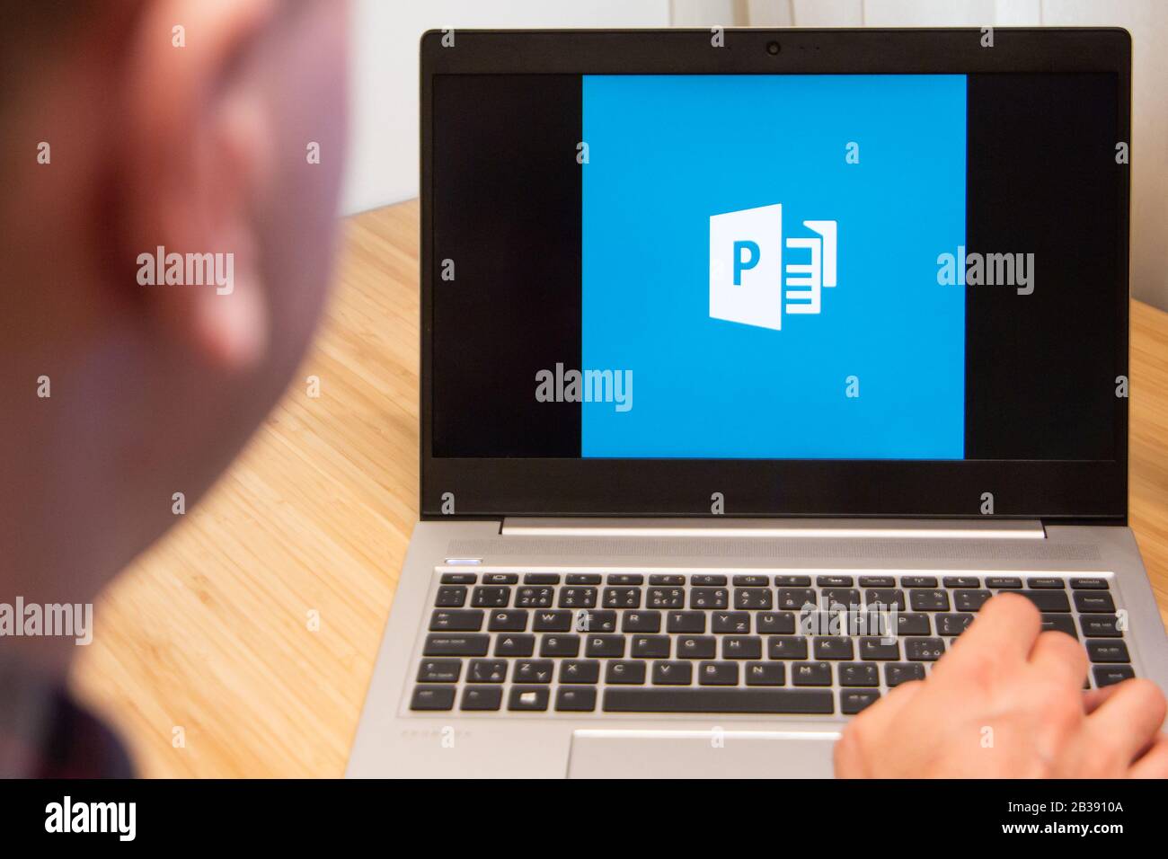 Publisher is used by a man on the laptop. Microsoft customer used computer software. New product is tested by IT specialist. San Francisco, February Stock Photo