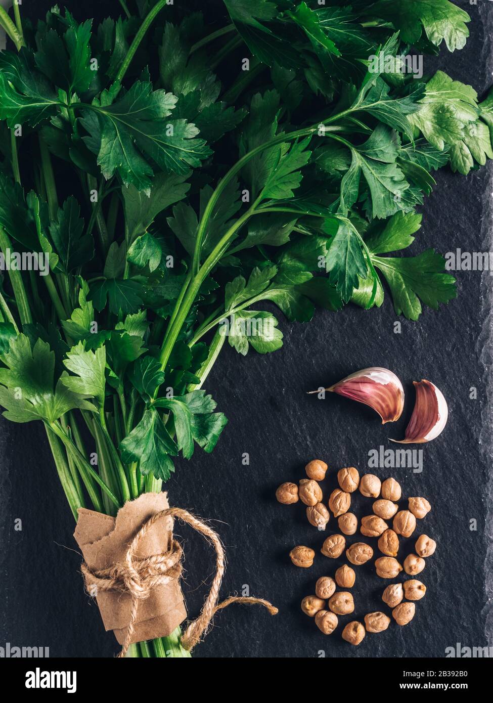 freshness parsley, garlic and chickpeas  . Bunch of parsley, green organic herb. Vegetable ingredient for healthy tasty food. Stock Photo